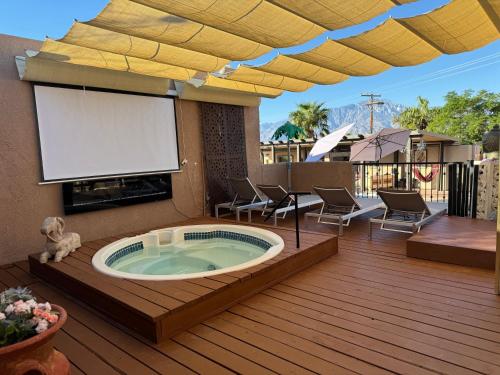 a hot tub on a deck with a patio at MI KASA HOT SPRINGS 420,Adults Only, Clothing Optional in Desert Hot Springs