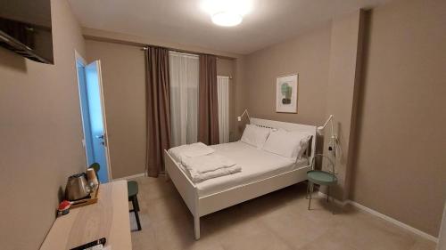 ein Schlafzimmer mit einem weißen Bett und einem Fenster in der Unterkunft Casa Franciacorta in Gussago