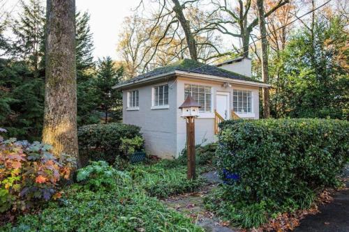 a small white house in the middle of a yard at Executive Studio - Walk to Emory & CDC in Atlanta