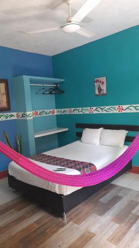 a bed with a pink hammock in a room at Casa Atrapasueños in Valladolid