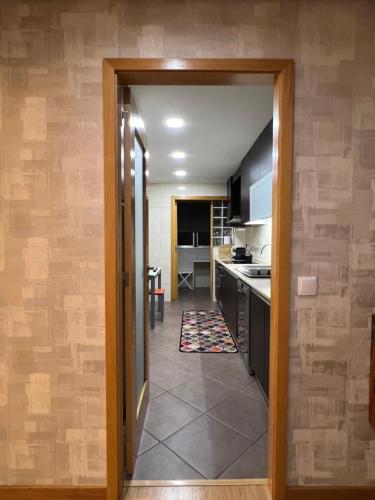 a kitchen with a door leading to a dining room at Douro Residence Porto Gaia in Vila Nova de Gaia