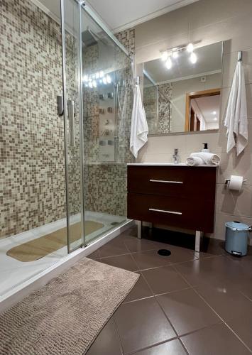 a bathroom with a shower and a sink at Douro Residence Porto Gaia in Vila Nova de Gaia