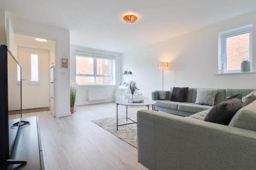 a living room with a couch and a table at Modern Spacious 3 Bedroom House in Canterbury with En Suite and Free Parking Perfect for Contractors & Families in Canterbury