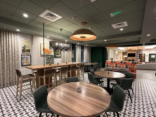 a restaurant with tables and chairs in a room at Cambria Hotel El Centro - Imperial in El Centro