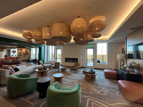 a lobby with couches and chairs and chinese lamps at Cambria Hotel El Centro - Imperial in El Centro