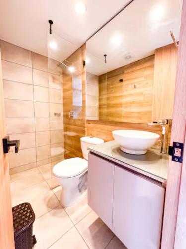 a bathroom with a toilet and a sink at Skyline Suites - Elegant Living with Coworking & Scenic Views in Bogotá