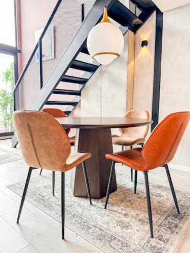 a dining room with a table and chairs at Skyline Suites - Elegant Living with Coworking & Scenic Views in Bogotá