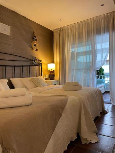 a bedroom with two beds and a window at Beautiful Marbella Apartment in Marbella