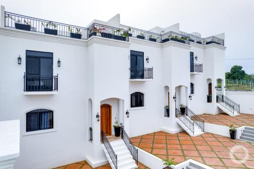 a white house with stairs and a balcony at Las Haciendas in San Ignacio