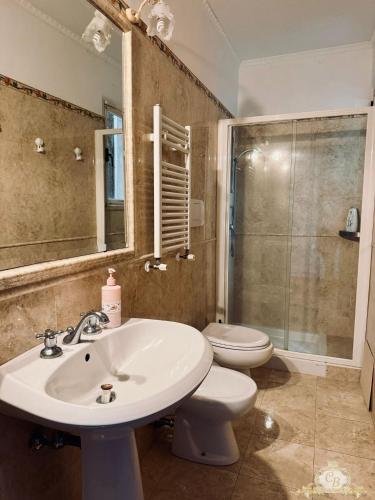 a bathroom with a sink and a toilet and a shower at Casa belvedere anzio in Anzio