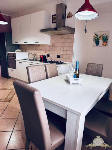 a kitchen with a white table and some chairs at Casa belvedere anzio in Anzio