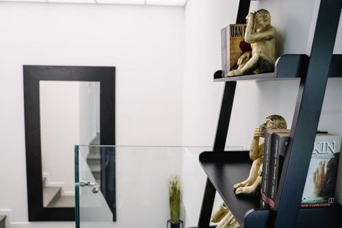 a room with a glass shelf and a mirror at Aspa Luxury Garden Apartment in Vouliagmeni Center in Athens