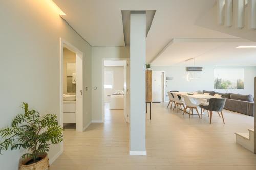 a living room and dining room with a table and chairs at Dunas Villa in São Jacinto