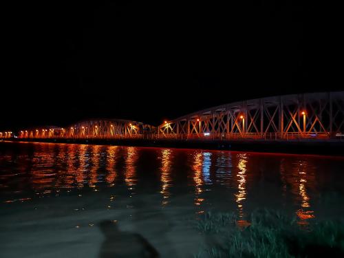 a bridge over a body of water at night at Chez saly in Saint-Louis
