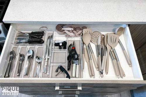 a drawer filled with utensils in a kitchen at Modern Retreat - 3 King Beds - Garage - WiFi - Sleeps 10 in Edmonton