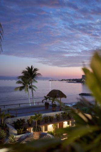 a view of a body of water with palm trees at Hotel Ysuri Bucerias in Bucerías