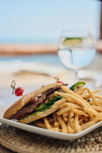 a plate of food with a sandwich and french fries at Hotel Ysuri Bucerias in Bucerías