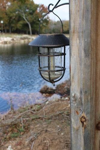 a lantern hanging on a wooden pole with a body of water at DazeOFF Too Suite 7 - Pet Friendly Suite by The Lodges at Fossil Creek in Shay