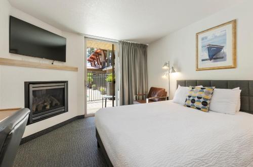 a hotel room with a bed and a fireplace at Firelite Lodge in Tahoe Vista