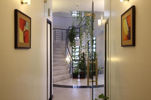 a hallway with a glass door leading to a staircase at The Saneer Jaipur in Jaipur
