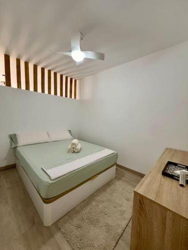 a bedroom with a bed and a ceiling fan at Costa Adeje Relax y vistas al mar desde terraza in Adeje