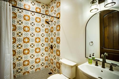 a bathroom with a toilet and a sink and a mirror at Las Haciendas in San Ignacio
