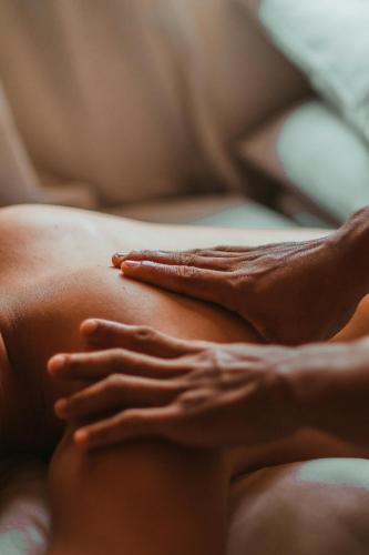 a woman with her hands on her stomach at Charlesworth Bay Beach Resort in Coffs Harbour