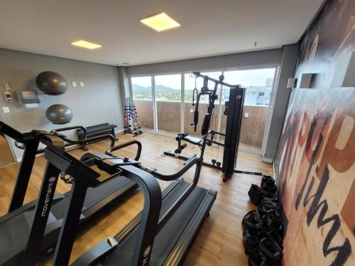 a gym with treadmills and cardio equipment in a room at HOTEL BOSSA NOVA 224 - Ótimo Apto com cozinha para até 03 hóspedes in Cabo Frio