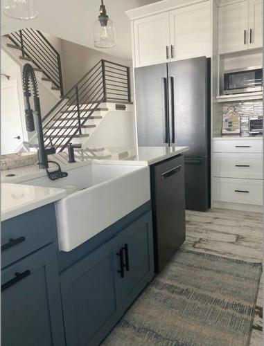 a kitchen with a sink and a refrigerator at Newly built home in Cudjoe Key in Cudjoe Key