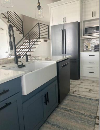 a kitchen with a sink and a refrigerator at Newly built home in Cudjoe Key in Cudjoe Key