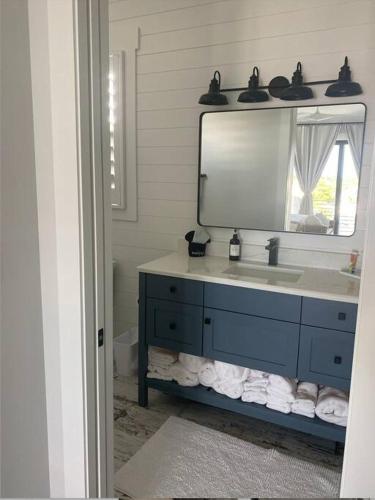 a bathroom with a blue sink and a mirror at Newly built home in Cudjoe Key in Cudjoe Key