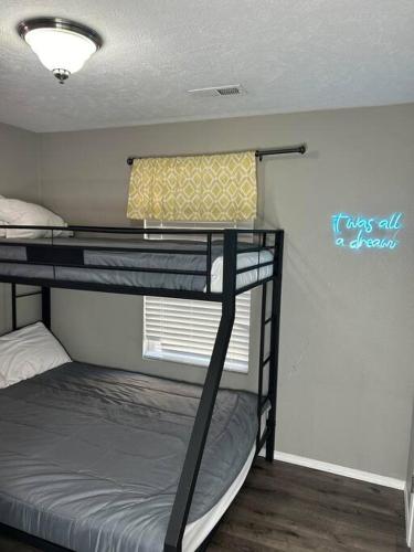two bunk beds in a room with a window at Beautiful condo-no stairs, and arcade games! 5bed in Branson