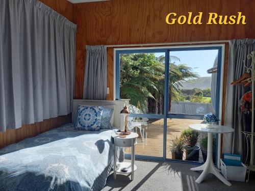a bedroom with a bed and a large sliding glass door at Charleston Goldfields Accommodation in Charleston