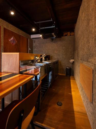 a large kitchen with wooden counters and stainless steel appliances at Wadami384 in Matsue