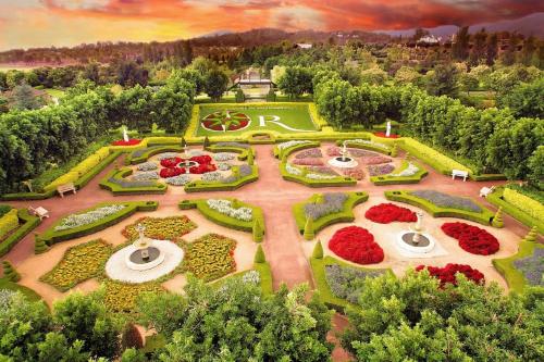 an aerial view of a garden with red flowers at Pineapple House Furry Friends Welcome in Cessnock