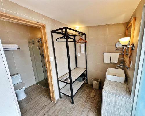 a small bathroom with a shower and a toilet at Hotel Ciudad Real Centro Historico in San Cristóbal de Las Casas