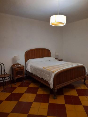 a bedroom with a bed and a table and a lamp at Casa Quinta Estilo Campo in Lobos