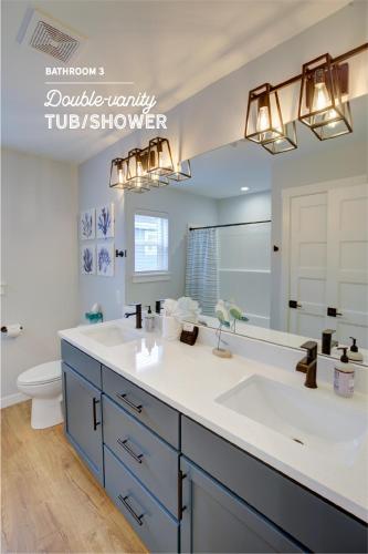 a bathroom with a sink and a large mirror at Heron's Haven On The Canal in Ocean Shores