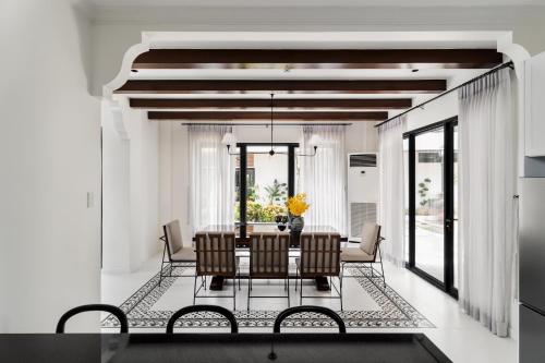 a dining room with a table and chairs at Bayandati Resort in Bataan