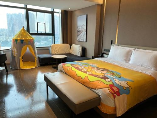 a hotel room with a bed and a play tent at Atour Hotel Guangzhou Liwan District Jiaokou in Guangzhou