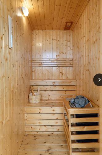 a sauna with wooden walls and wooden floors at Dolphin Hotel and Apartment in Da Nang