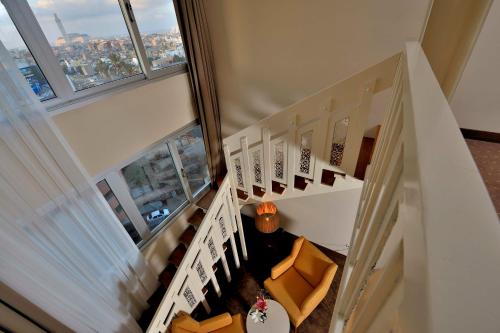 an overhead view of a staircase with chairs and windows at Kenzi Basma in Casablanca