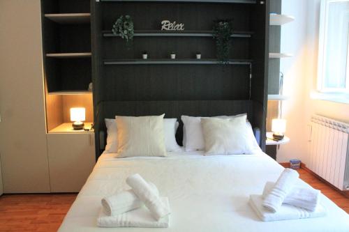 a bedroom with a large white bed with two pillows at Terrace44 Oasi di pace e relax nel cuore di Trieste in Trieste