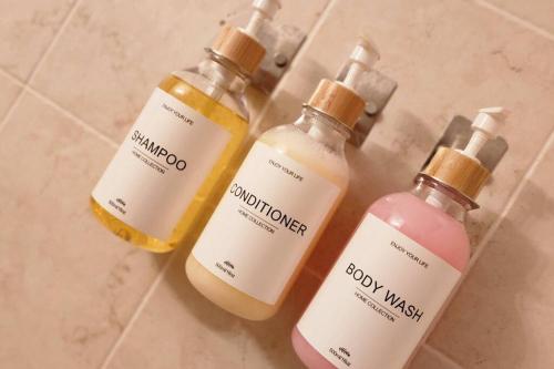 a group of three bottles of soap on a counter at Trinitarias House Piscina karaoke Bar wifi in Salinas