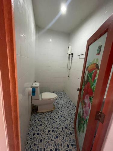 a bathroom with a toilet and a phone at Sai Rung Farmstay สายรุ้ง ฟาร์มสเตย์ in Ban Huai Yung