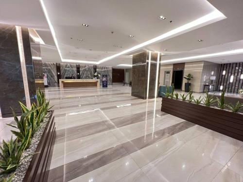 a lobby of a building with a reception desk at 2BR Solana Suite near MOA PICC NAIA in Manila