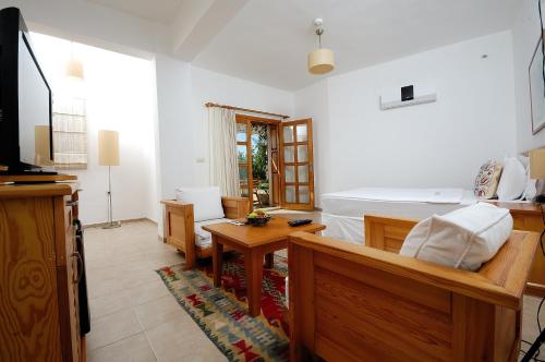 a living room with a bed and a table at Lycia Hotel in Kas