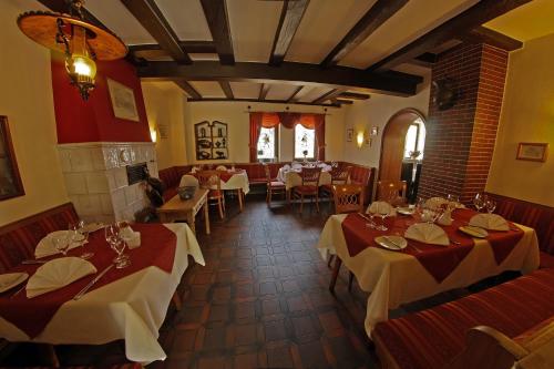a restaurant with tables and chairs in a room at Gasthaus zum Ochsen in Mannheim