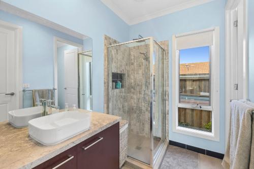 a bathroom with a sink and a shower at Serenity Nook Cottage in Point Lonsdale