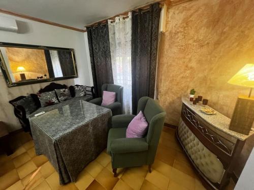 a living room with a couch and a table and chairs at Villa Rural El doncel in Hellín